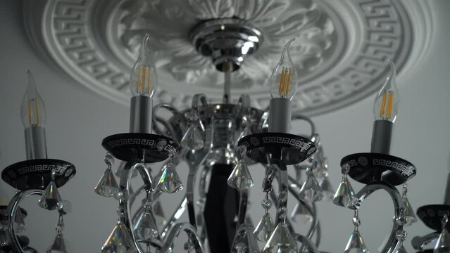 The chandelier swings from buildings shaking during an earthquake.