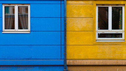 blue and yellow wall with windows