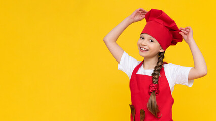 A child in a cook costume on an isolated background, a little beautiful girl is going to cook food, the concept of cooking by children.