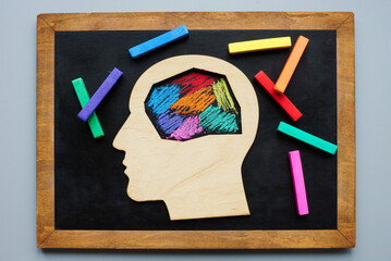 The head is painted with colored crayons. Neurodivergent concept.