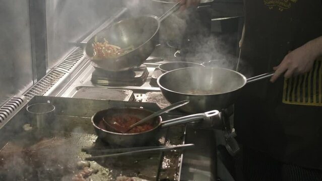Professional Kitchen Pans with Food Cooking on Stove Restaurant