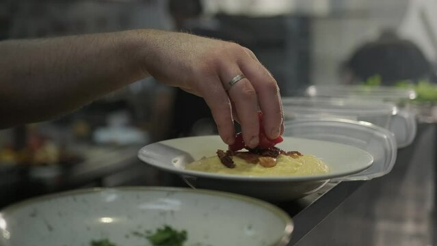 Chef Hand Plating Gourmet ish Decorating Food on Plae Restaurant
