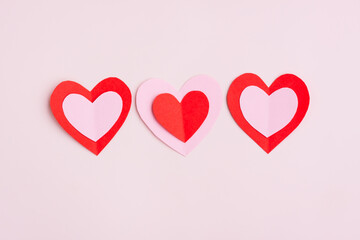 Obraz na płótnie Canvas Red and Pink Paper Hearts on pink background, Heart shape papercut , Happy Valentine's day