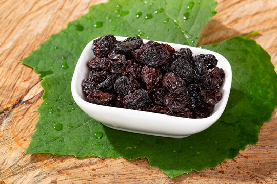 Healthy Food - Nuts Dehydrated Grapes; Photo On Wooden Background