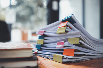 The stacks of documents lying on the desk are waiting to be verified before being sent to the Board...