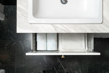 toilet tissue rolls storage in box of cupboard in restroom