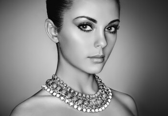 Portrait of young beautiful woman with perfect makeup. Face Girl with necklace close up. Fashion...