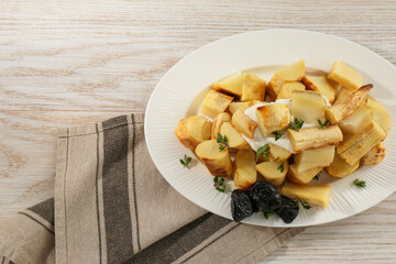 Tasty homemade parsnips with prunes and thyme on white wooden table, top view. Space for text