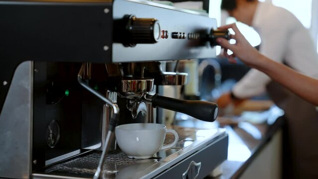 4K, Barista water white coffee mug is a mug for hot coffee, put under coffee machine which is distilling coffee water, flows through handle coffee maker, Into a coffee mug ready to serve.