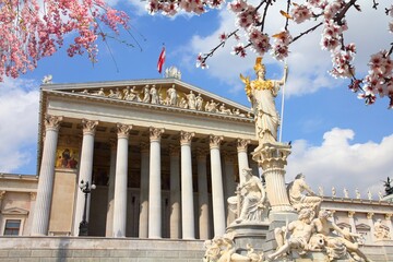 Austrian Parliament building in Vienna. Spring time cherry blossoms.