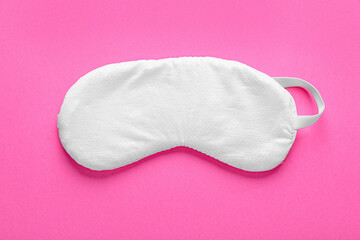 Soft sleep mask on pink background, top view