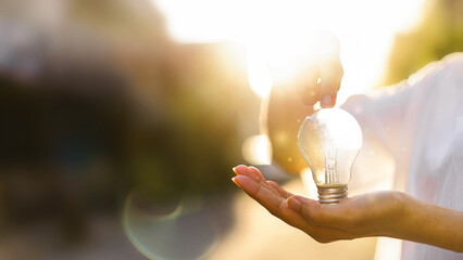 Innovate through ideas and inspiration. human hand holding light bul