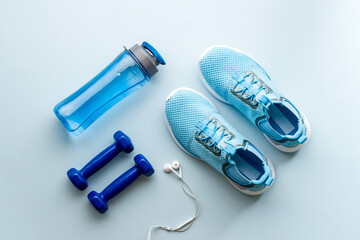 Gym and fitness equipment and workout tools with sneakers and dumbbells