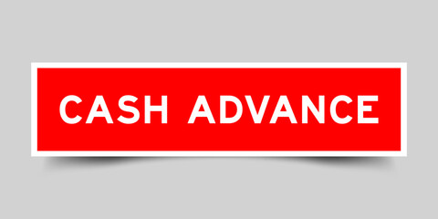 Red color square label sticker with word cash advance on gray background
