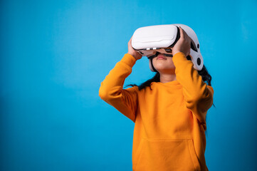 the studio isolated a portrait image of the girl wearing the VR goggle with the technology concept