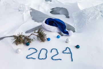 Merry Christmas and Happy New Year. Christmas composition with blue Santa's hat, pine branch with...