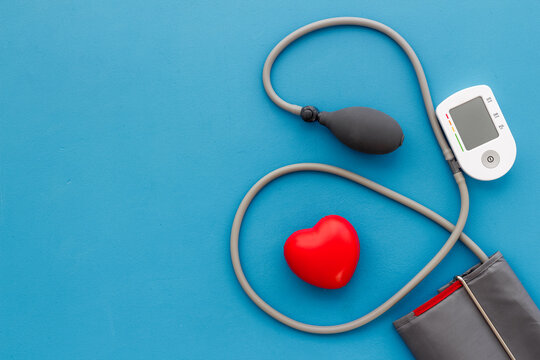 Red heart and blood pressure monitor. Heart diseases diagnosis concept