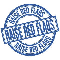 Fototapeta premium RAISE RED FLAGS written word on blue stamp sign