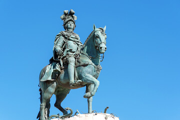 portuguese horse and rider statue against a blue sky