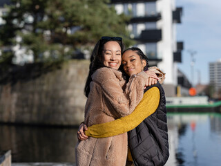 Two young women posing for portrait in urban setting