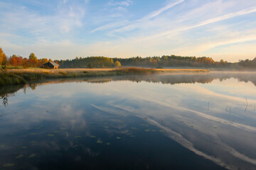 Morning on the misty lake in autumn