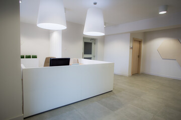 Modern medical reception. White waiting room interior. Receiving patients. Aesthetic medicine. Private offices.