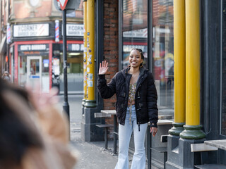 Two young women meeting in street