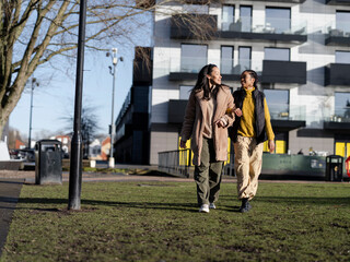 Two young women hanging out in urban setting