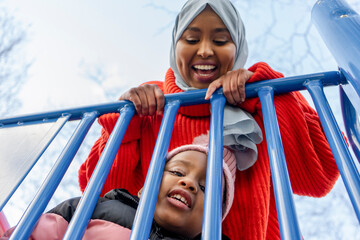Mother and daughter (2-3) in playground