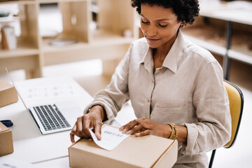 Creative businesswoman preparing an online order for delivery