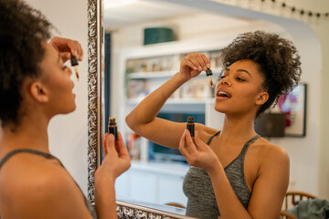 Young woman taking supplements at home