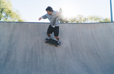 Skateboarder performing extreme trick riding on ramp