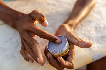 Fototapeta Close-up of male hands applying sun lotion obraz