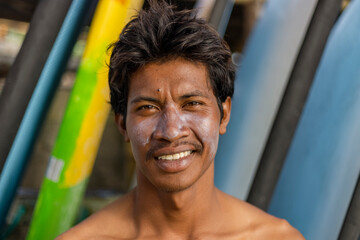 Fototapeta Portrait of smiling surfer with sun lotion on face obraz