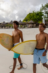 Fototapeta Indonesia, Lombok, Two surfers walking with surfboards on beach obraz