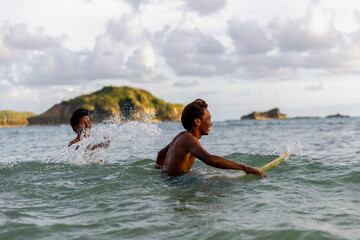 Fototapeta Indonesia, Lombok, Two surfers enjoying surfing in sea obraz