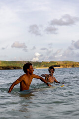 Fototapeta Indonesia, Lombok, Two surfers enjoying surfing in sea obraz