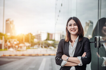 Portrait of Asian business woman smiling and embrace outdoor of her office or airport