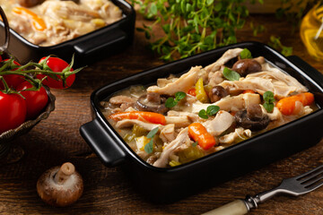 Chicken casserole. Served in black pots.