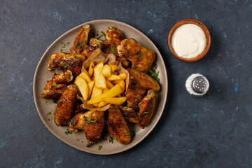 Baked chicken wings. Served with sauce or fries.