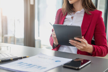 Marketing, Financial, Accounting, Planning, The president of the company sits in his office with a tablet, calculator, pen and graph paper attached to a blackboard for his work.