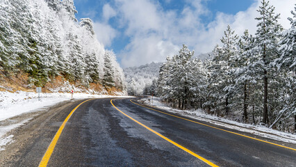 Mountain road landscape covered in snow in winter - 568792881