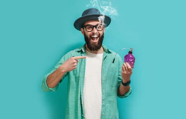 Funny rastaman hipster guy smokes marijuana through a bong and blows smoke.
