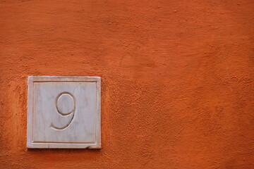Number nine on red wall