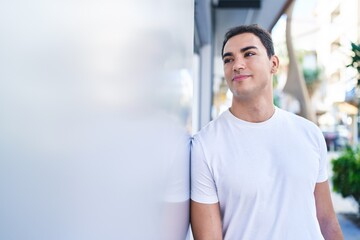 Fototapeta na wymiar Young hispanic man smiling confident standing at street