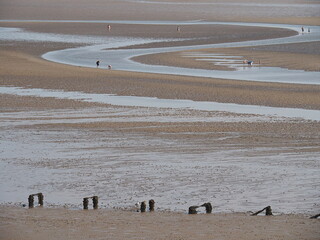 Llandudno beach at low tide with stream and people