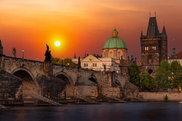 Prague with Old Town Bridge Tower and Charles bridge over Vltava river at sunset, Czechia