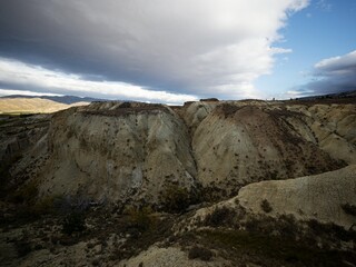 Arid barren badland, wild west desert landscape of Bannockburn Sluicings in former goldmine in Central Otago New Zealand