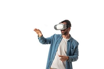 Attractive bearded man playing video games with virtual reality headset, trying to touch something with hand isolated on white background