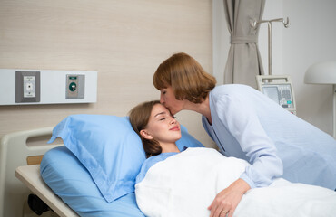 A mother blankets her child who is hospitalized. Show your love and concern with a kiss before bedtime.